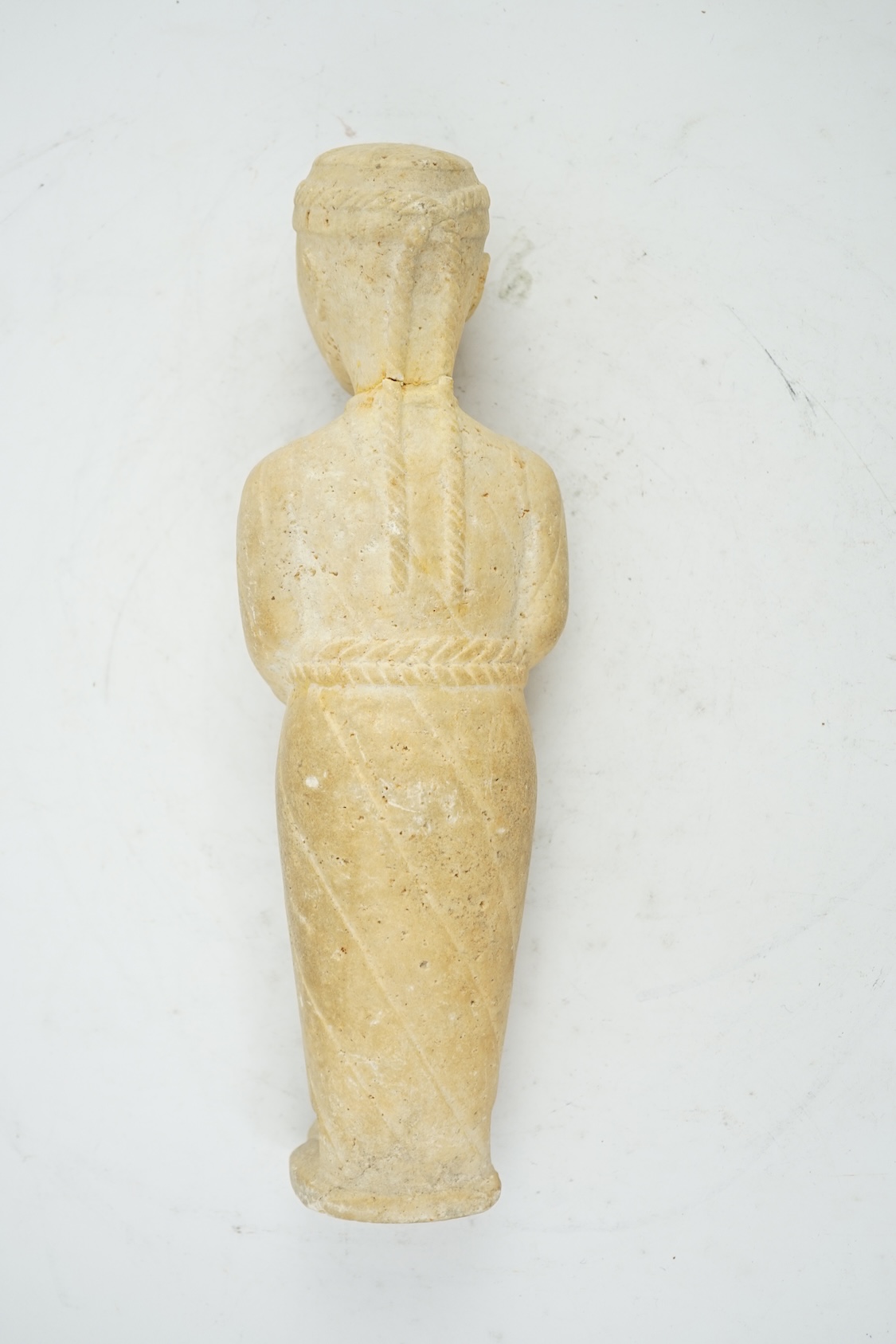 An unusual limestone votive figure, with cuneiform inscription, possibly Mesopotamian